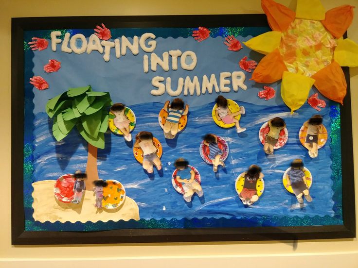 a bulletin board with paper flowers and people in the water on rafts under a sunflower