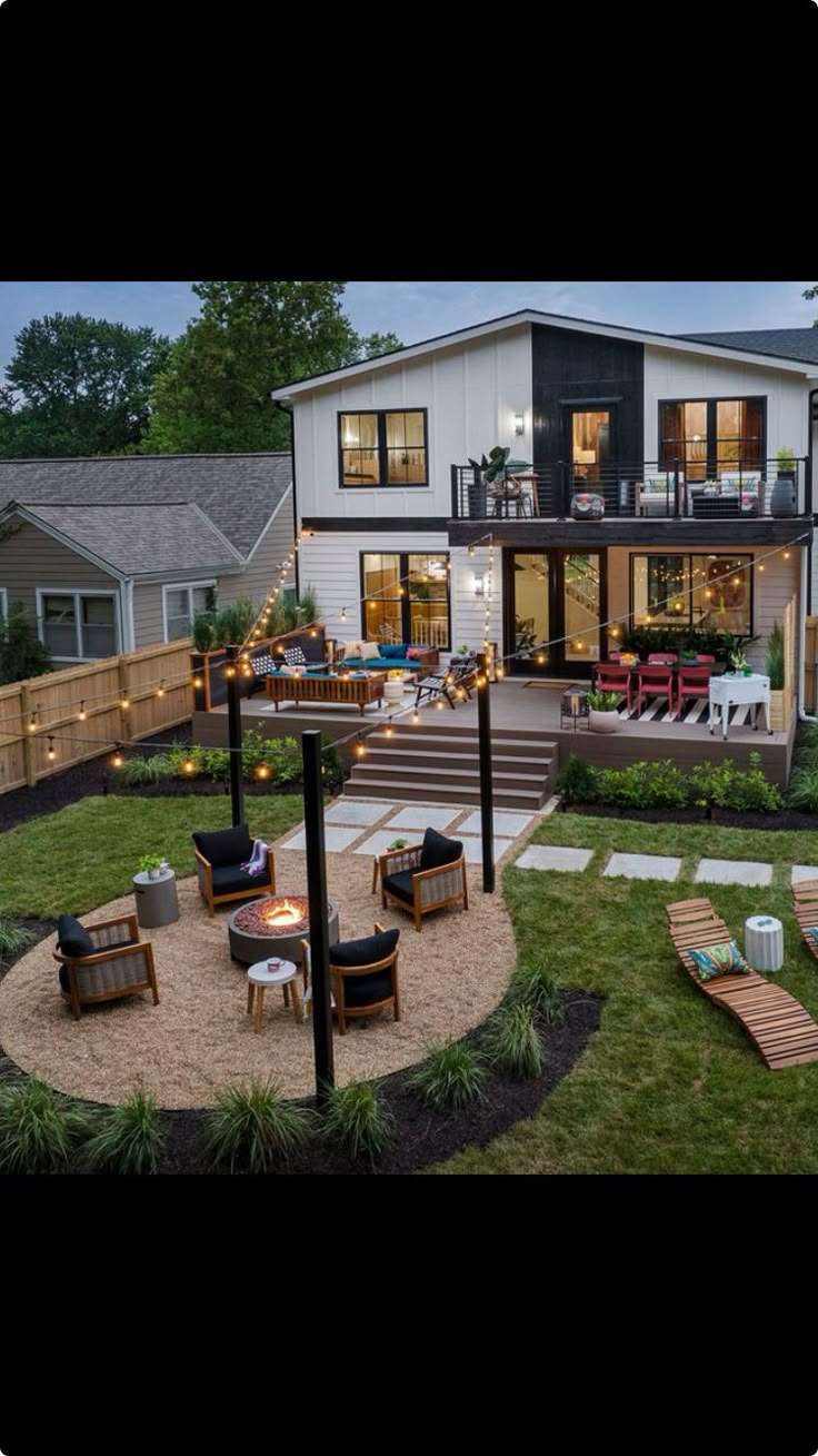 an aerial view of a backyard with patio furniture and lights on the deck, as seen from above