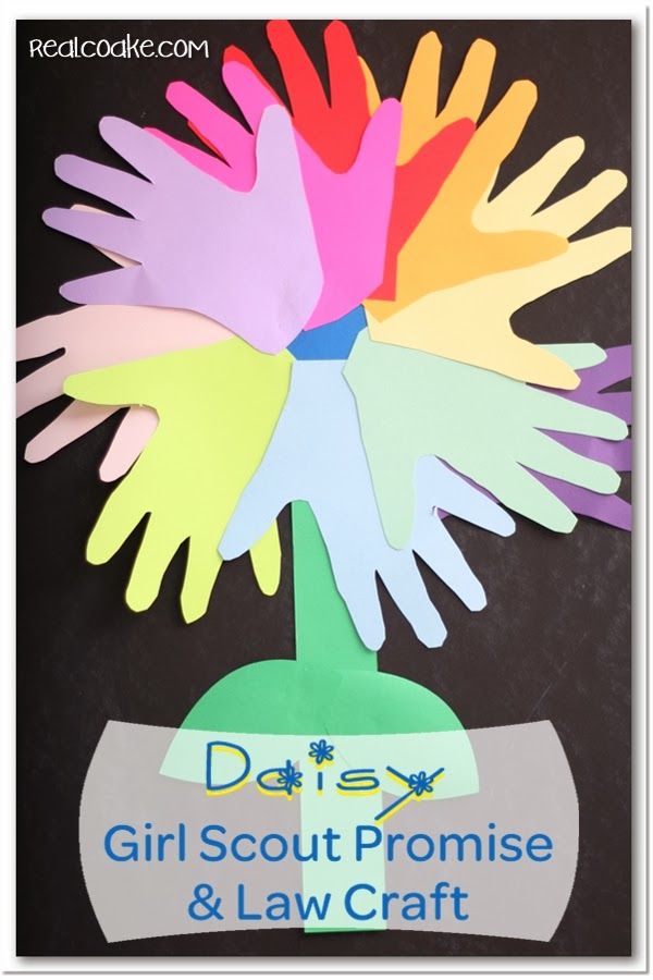 handprinted flowers made out of paper with the words daisy girl scout promise and law craft