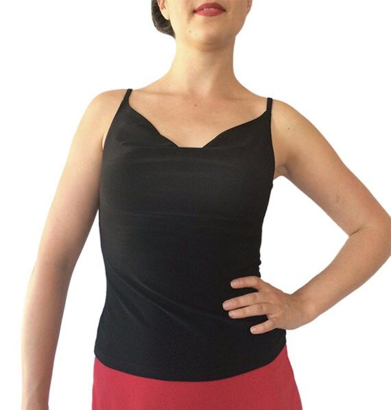 "Classic, all-around cami showcases your fabulous skirts and pants. Draped front and back necklines. Partially lined bodice. 5\" spaghetti straps work with most bras. Item #TL202. Soft, silky and stretchy poly/spandex jersey. Size: -Sizes 4 through 16 Fabric & Care: -Easy care, no-wrinkle poly/spandex -Hand wash cold. Hang dry. Overview: -Great for travel - rolls up small. -Handmade in our studio in Santa Fe, New Mexico USA. Questions about fabric, fit or size? Email me. I am delighted to he Elastane Camisole Tank Top For Party, Elastane Camisole With Built-in Bra, Party Elastane Camisole Tank Top, Fitted V-neck Top With Lined Body, Elegant Sleeveless Halter Top With Built-in Bra, Chic Stretch Camisole, Chic Stretch Elastane Camisole, Bra-friendly Fitted V-neck Tank Top, Fitted Camisole With Built-in Bra For Evening