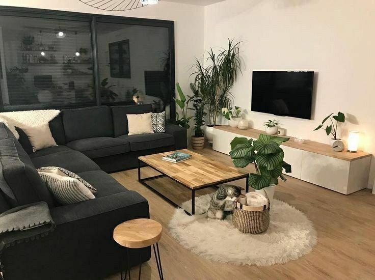 a living room filled with furniture and a flat screen tv mounted to the side of a wall