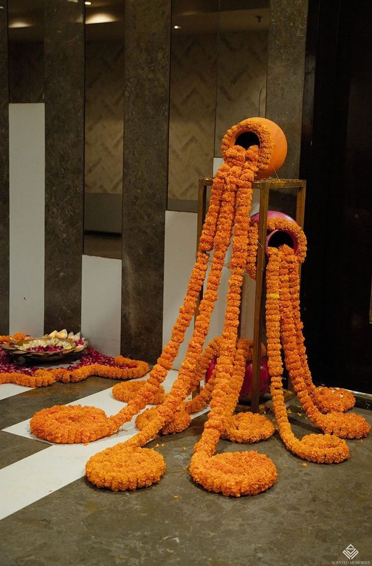 an arrangement of orange flowers on the ground