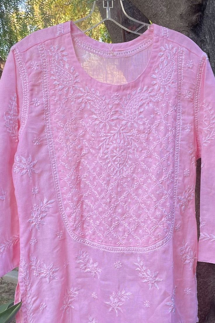 Hand Embroidered Women's Soft Pink Cotton Linen Lucknowi Chikan Kurta is ideal for any situation. It is composed of cotton linen and showcases full Lucknowi Chikankari Embroidery Handwork. The kurta offers a comfort-forward and laid-back silhouette, and the fabric and embroidery is gentle on the skin. Length 46" inches Long sleeves 18" inches Round neck Side Slit Thread work Cotton Chikankari embroidery Handwork Dry Clean Disclaimer: Since the product is hand embroidered, Motifs may vary slightl Phulkari Pants, Chikan Kurta, Lucknowi Kurta, Gharara Suits, Patiala Salwar Suits, Chikankari Embroidery, Bridal Dupatta, Phulkari Dupatta, Chikankari Suits