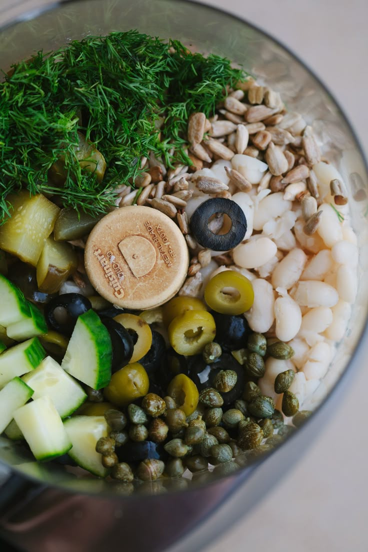 a food processor filled with vegetables and nuts