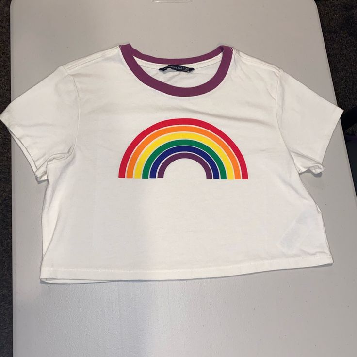 Never Worn But Tags Off. New Condition. Super Soft And Cute! Has A Vintage Look To It. Comes From A Smoke Fee And Pet Free Home. Comment If Any Questions! Open To Offers. Rainbow Fitted Crew Neck Top, Fitted Rainbow Crew Neck Top, Fitted Rainbow Print Short Sleeve Top, Fitted Rainbow Casual Top, Fitted Casual Rainbow Tops, Fitted Rainbow Short Sleeve Tops, Cute Cropped White Top, Cute White Cropped Top, White Cotton Crop Top Shirt