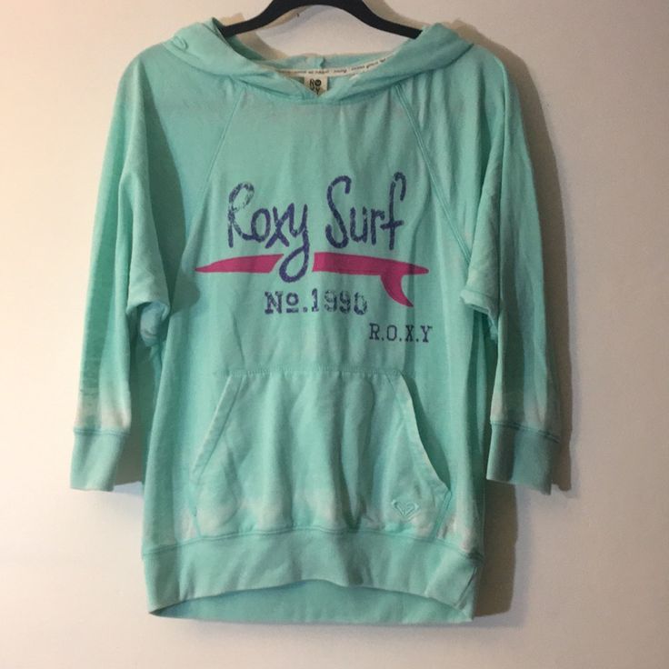 Roxy Graphic Hooded Tee Never Worn Perfect Condition Cozy Fit Green Top For Spring, Spring Green Cozy Fit Top, Pink Hoodie Tops For Loungewear, Comfy Green Cotton Top, Cozy Pink Hoodie Top, Green Stretch Top With Drawstring Hood, Cozy Pink Top With Drawstring Hood, Pink Drawstring Hood Top For Loungewear, Pink Stretch Hoodie Top