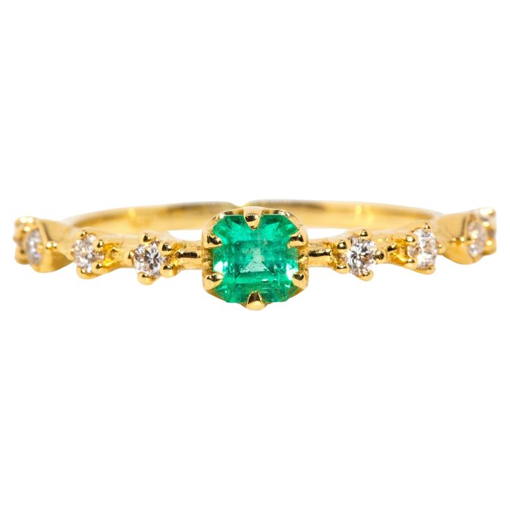 Crafted in 18 carat yellow gold, this delightful contemporary ring holds an alluring natural green emerald flanked by eight glistening round brilliant cut diamonds shimmering in unison. Her name is The Ruri Ring, the perfect ring for stacking with other beloved gems and jewels or wearing alone. The Ruri Ring Gemstone Details The bright green square emerald cut emerald is 0.31 carats and measures approximately 4.00x3.87x3.2 millimetres. The round brilliant cut diamonds total 0.20 carats and F colour and VS clarity grades. Ring Size M (Australia and UK sizing) or 6 1/4 (US and Canada) The Ruri Ring can be resized prior to shipping upon request. Resizing is complimentary up or down three sizes or please message us for a quote if more sizes are needed. Great to Know The Ruri Ring belongs to ou Green Square, Contemporary Ring, Green Emerald, Ring Gemstone, Stunning Jewellery, Emerald Diamond, Natural Emerald, Gold Platinum, Perfect Ring