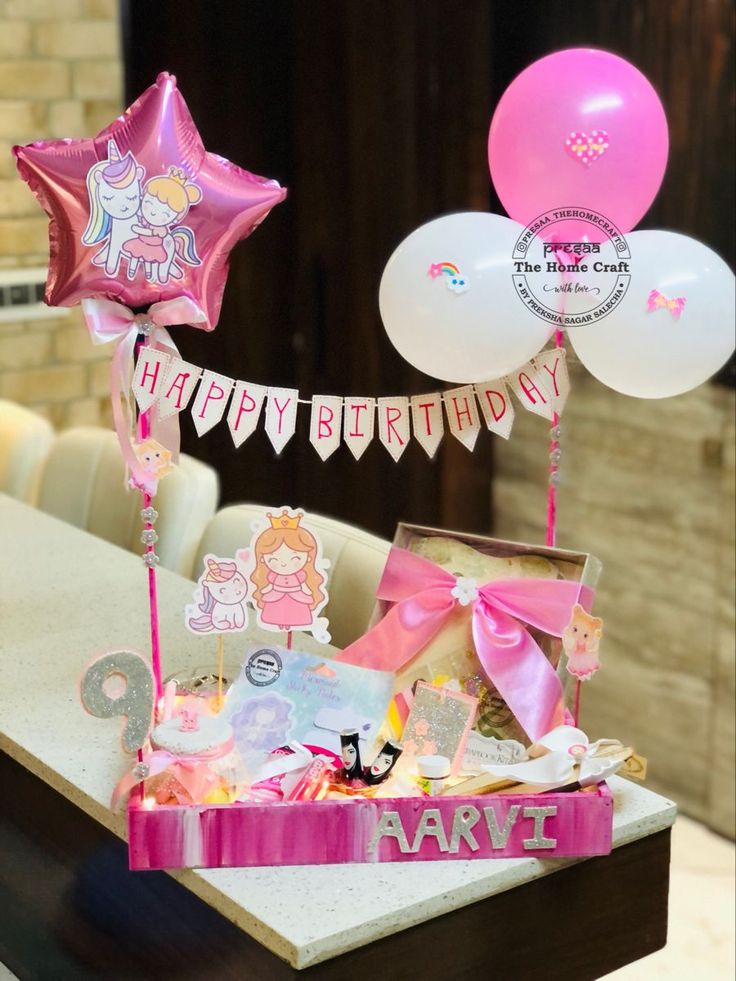 a table topped with balloons and other items