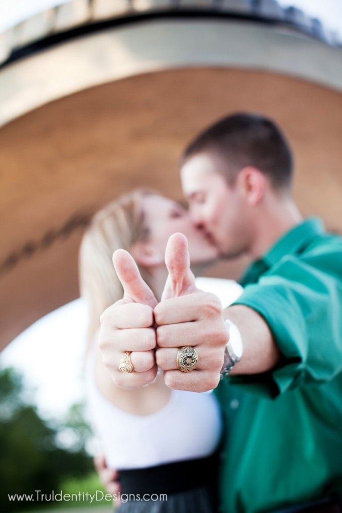 a man and woman giving the thumbs up sign with their fingers in front of them