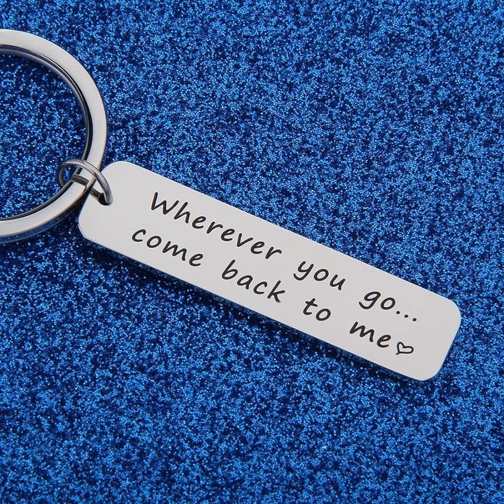 a silver keychain that says wherever you come back to me on blue carpet