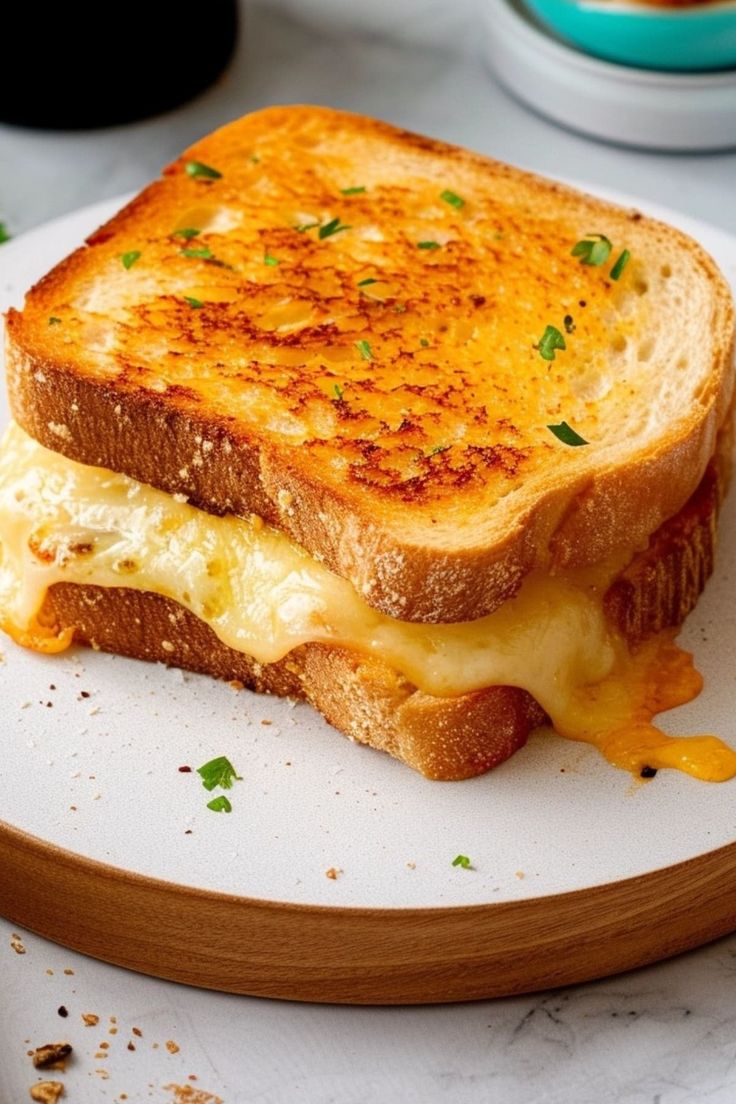 a grilled cheese sandwich sitting on top of a white plate