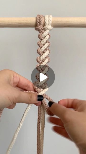 two hands are pulling the rope together to make an ornament for a curtain