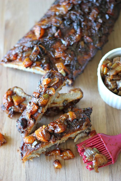 barbecue ribs with bbq sauce on the side and a red brush next to it