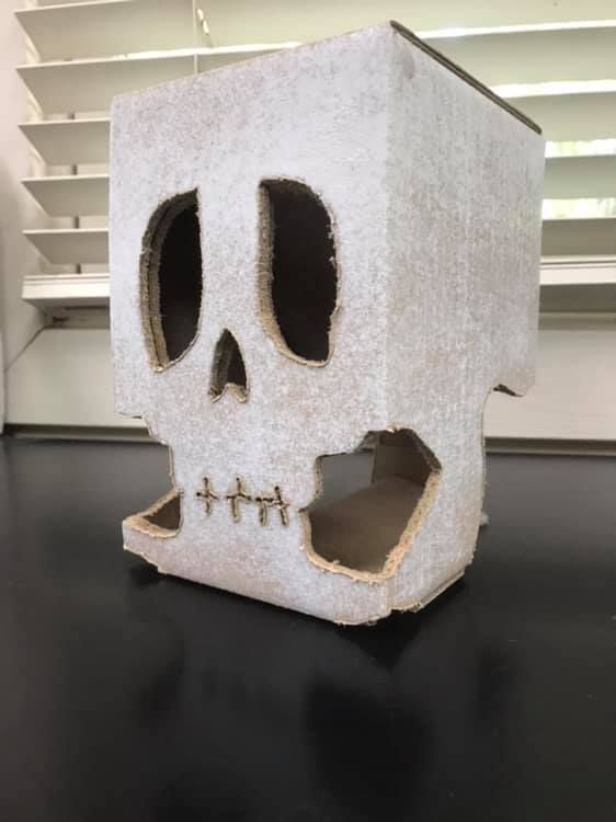 a skull shaped box with holes in it