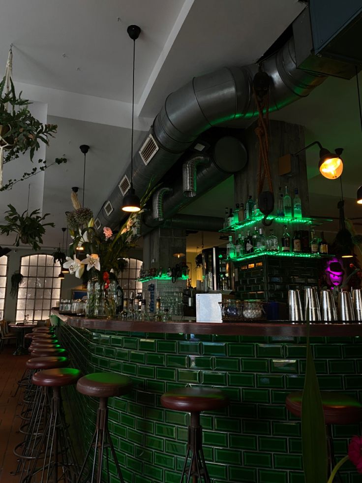 the interior of a bar with green tiles