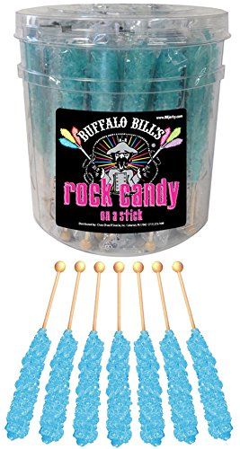 purple rock candy on a stick in a bucket with wooden sticks and plastic wrapper