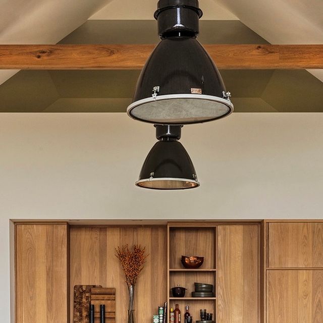 a kitchen with wooden cabinets and an overhead light