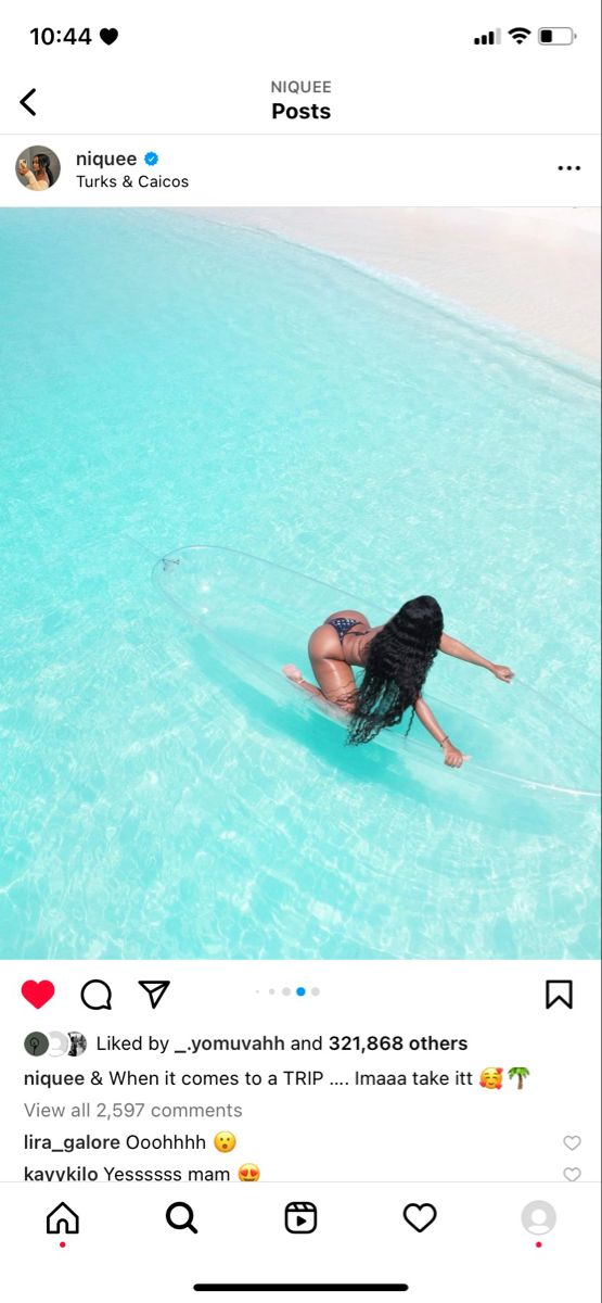 a woman is floating in the water on her surfboard