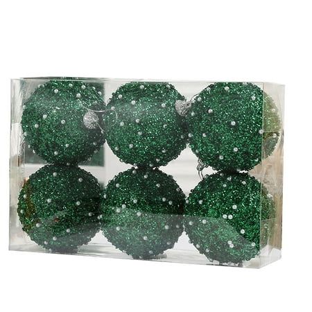 six green balls in a clear box with water droplets on them and white dots all over the surface