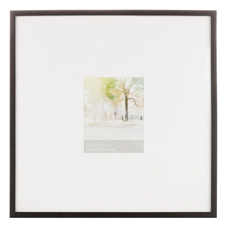 a white framed photograph with a tree in the background