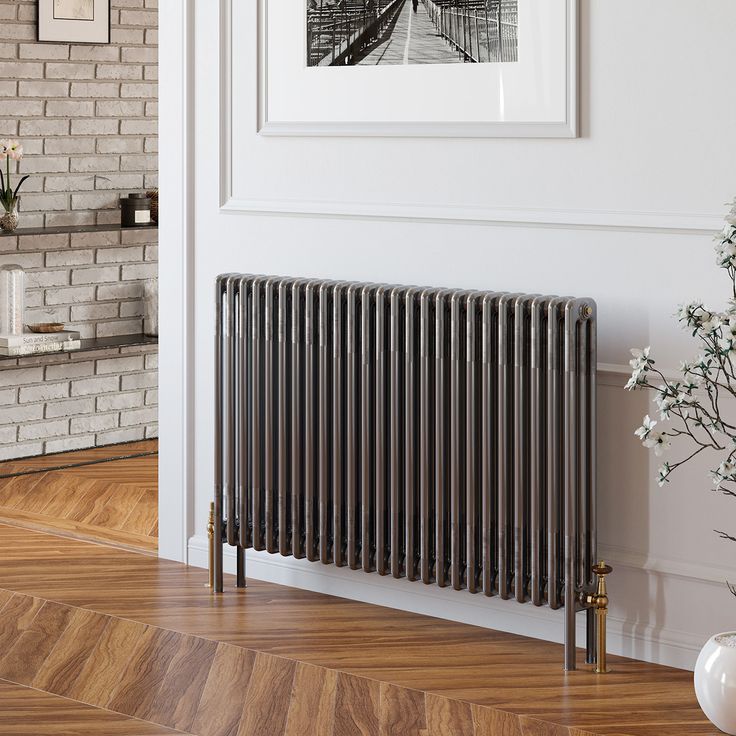 the radiator is next to a vase with flowers