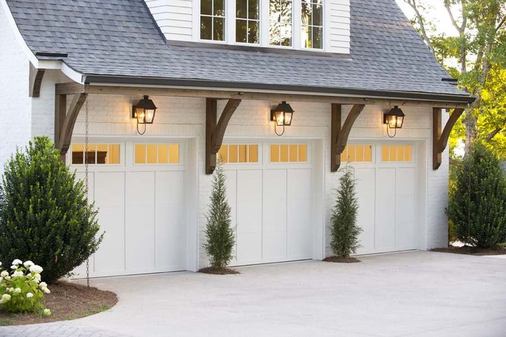 a white garage with three lights on each side