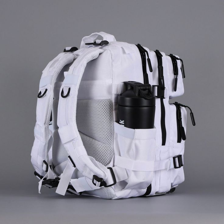 the back side of a white backpack with black straps and a coffee cup in it