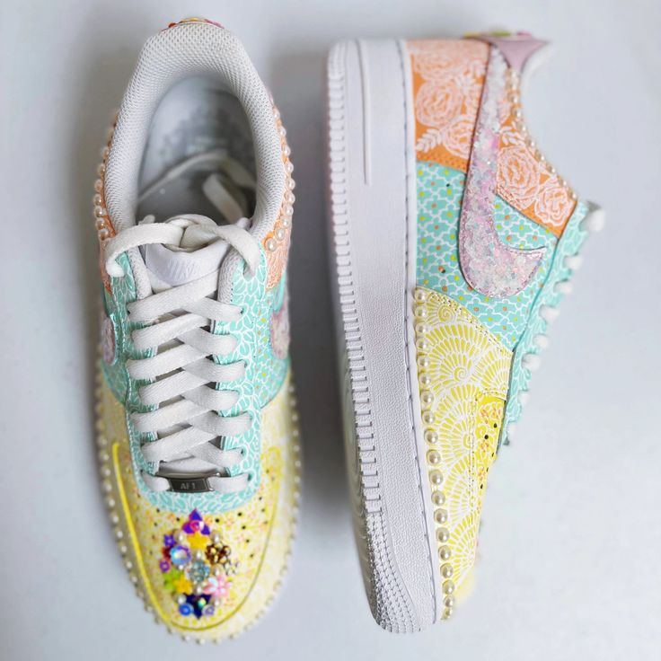 Neha Assar has literally given Nike AF1 sneakers a South Asian bridal makeover! These one-of-a-kind sneakers are hand painted with pale yellow, pastel mint and soft peach with matte white mehndi inspired art. The pattern play on these sneakers is what gives them personality. Moghul motifs are placed adjacent to florals on one side and intricate mehndi patterns on the other. The patterns should not be mistaken for being stenciled as each motif/line/curve/dot is done by hand. The shoes are hand em Yellow Custom Sneakers With Rubber Sole For Spring, Custom Yellow Sneakers With Rubber Sole For Spring, Pastel High-top Sneakers For Spring, Custom Yellow Lace-up Sneakers For Spring, Yellow Lace-up Custom Sneakers For Spring, Pastel Sneakers For Spring Streetwear, Sporty White Hand Painted Sneakers, Hand Painted Pink Sneakers For Spring, Pastel Lace-up Spring Sneakers