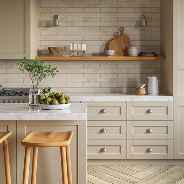 two wooden stools sit in front of a kitchen island with white countertops and open shelving