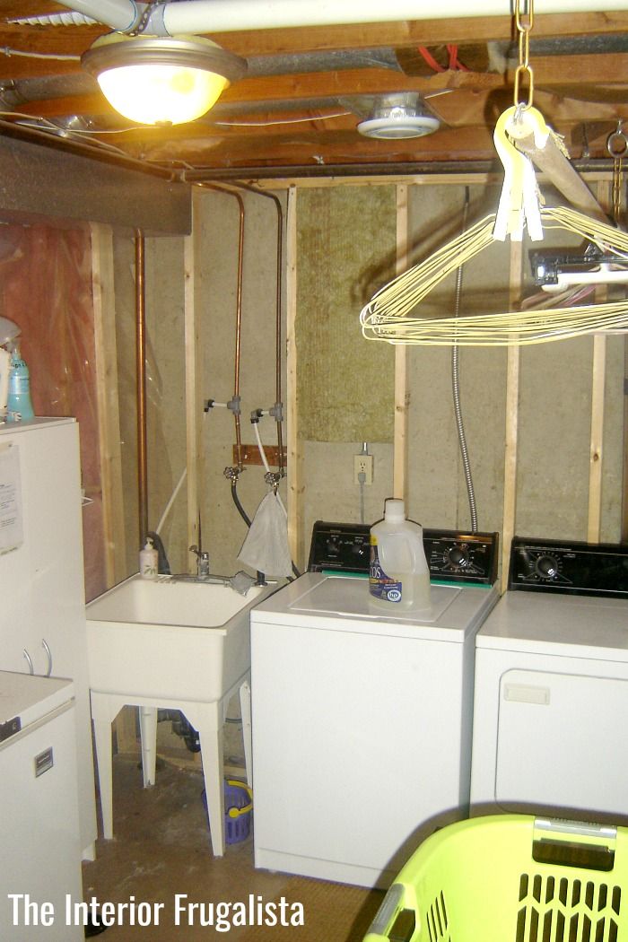 an unfinished kitchen with dryer and washing machine