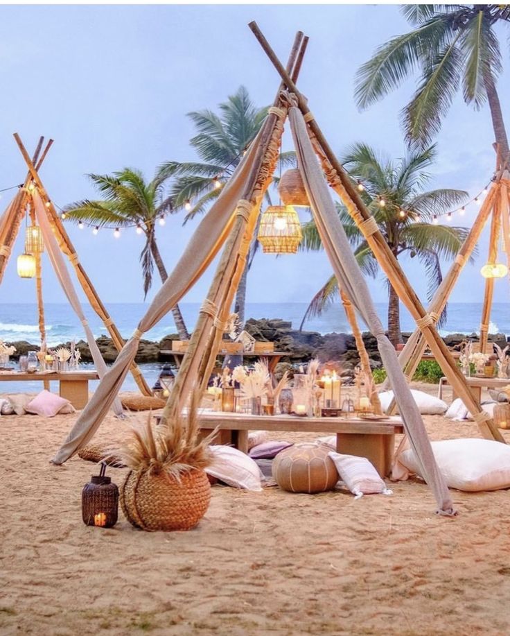 an outdoor setting with lights and pillows on the beach