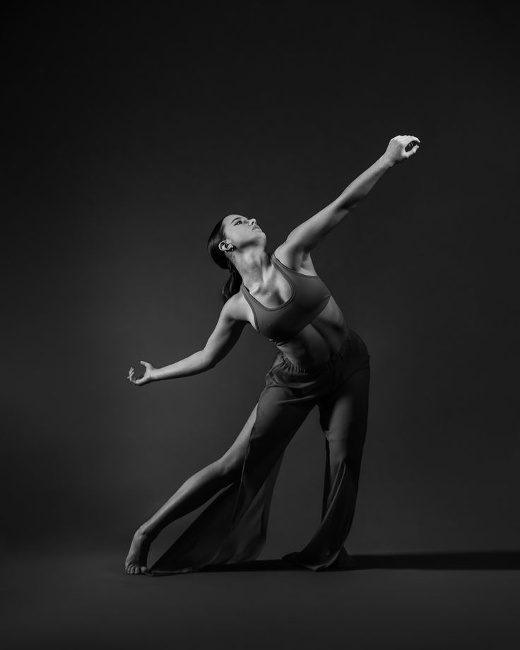 a black and white photo of a woman dancing