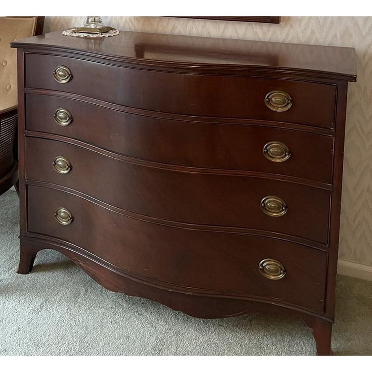 a wooden dresser sitting on top of a carpeted floor