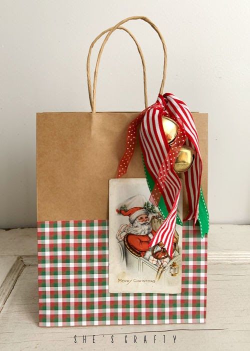 a brown paper bag sitting on top of a wooden table next to a christmas ornament