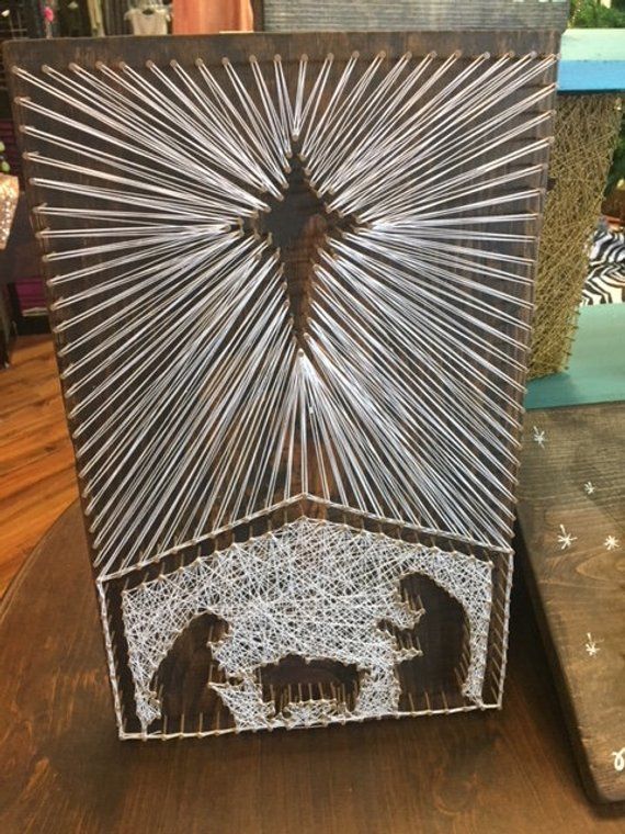 the nativity scene is made out of metal wire and has an elephant in it