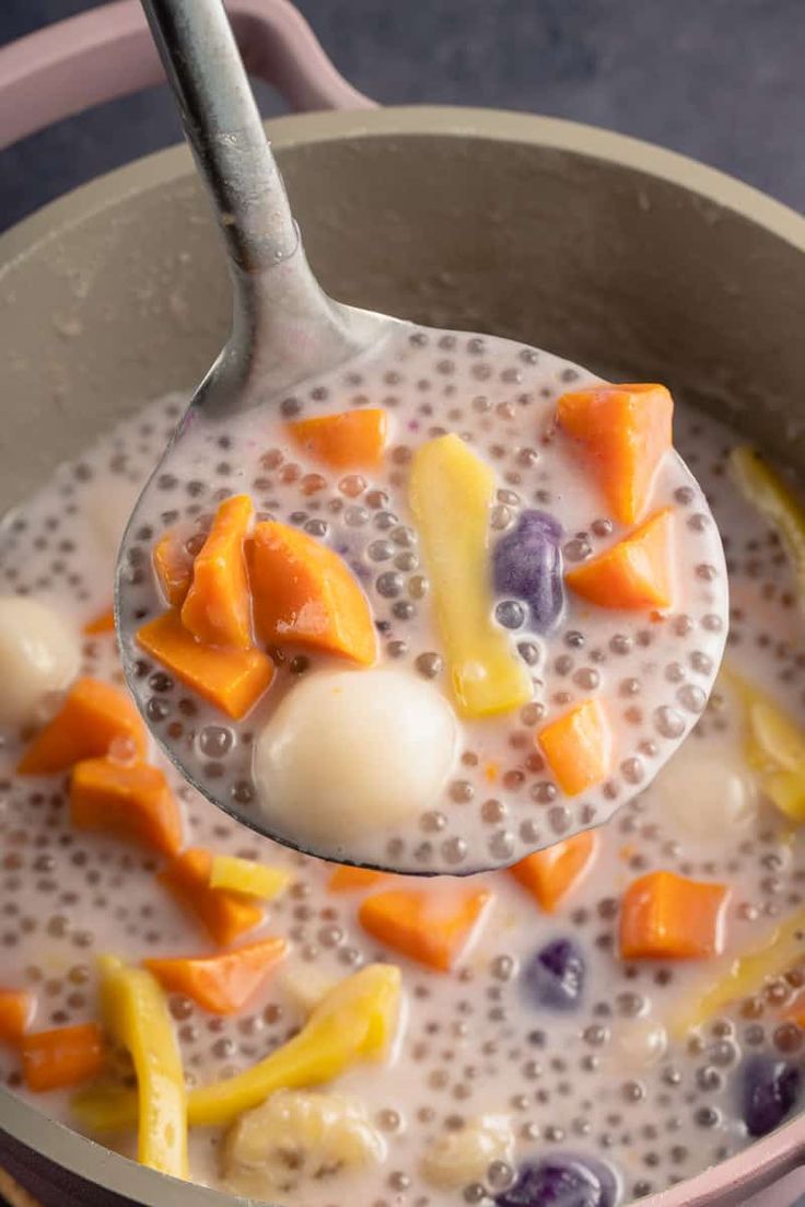 a spoon full of milk with fruit on it