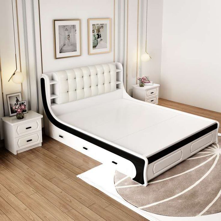 a white bed sitting on top of a hard wood floor next to a night stand