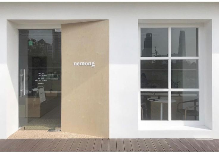 the entrance to an office building with large windows