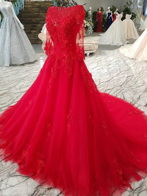 a red wedding dress on display in a store