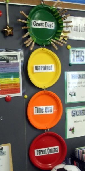 there are three frisbees hanging on the wall with magnets attached to it