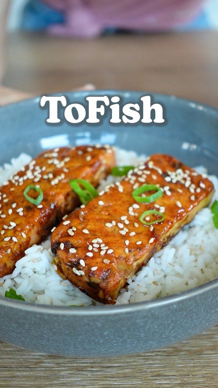 a plate with rice and meat on it that says tofish over white rice in the middle