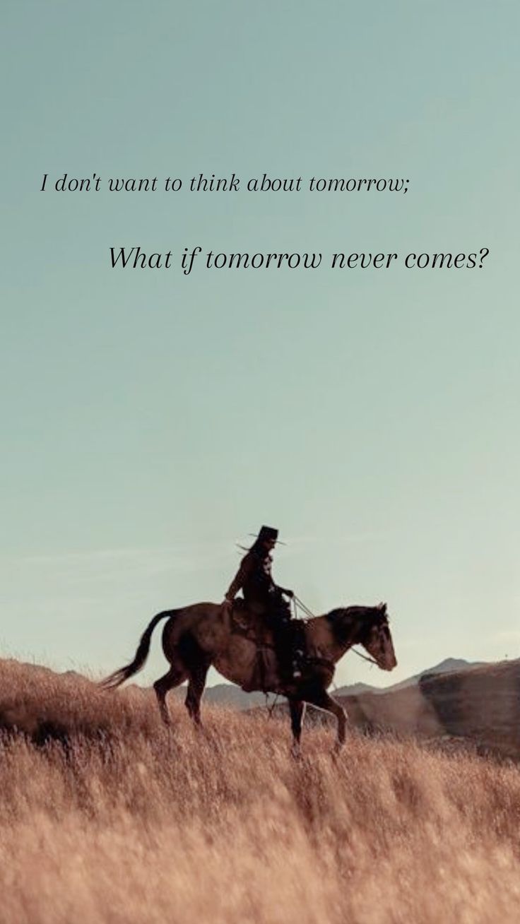 a man riding on the back of a brown horse in a dry grass covered field