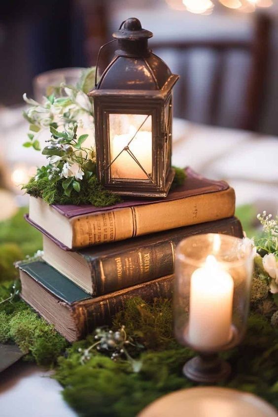 a stack of books sitting on top of each other with a lit candle in front of them