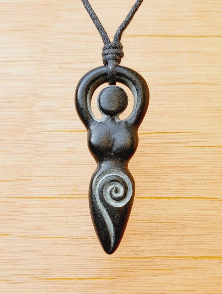 a black and white pendant on a wooden table