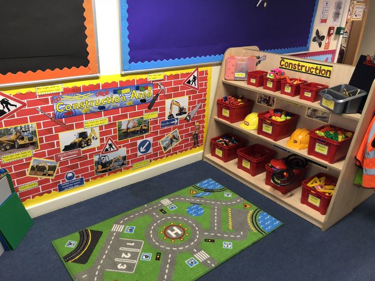 a child's playroom with toys and bookshelves on the floor,