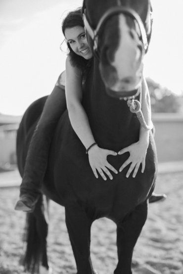 a woman riding on the back of a horse