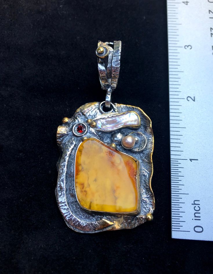 "Artisan Amber gemstone pendant Hand-made Sterling Silver 925,24k Gold Stones used: Baltic Amber, Pearls, Garnet Height - 3\" (with bail), Width - 1 1/2\" Height -75mm (with bail), Width - 38mm Unique Handcrafted One-of a-kind Design Pendant Each Piece of Jewelry in my Collection is Absolutely One of a Kind! When you start wearing a piece of my jewelry you will fall in love with it more and more each day and feel that good Energy and Love that I pass into it while creating this piece of Art. A p Unique Polished Pendant Necklace, Elegant Pendant Jewelry For Art Collection, Yellow Polished Pendant Jewelry, Yellow Pendant Jewelry With Polished Finish, Yellow Sterling Silver Pendant Jewelry, Hand Forged Amber Sterling Silver Jewelry, Artisan Yellow Pendant Jewelry, Unique Yellow Jewelry With Large Pendant, Unique Yellow Gemstone Jewelry