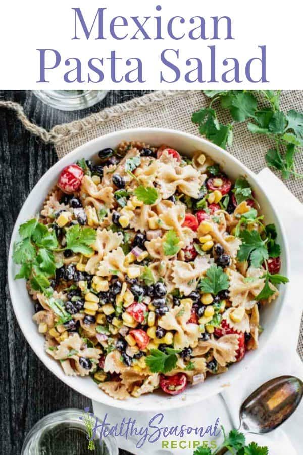 mexican pasta salad in a white bowl on top of a table