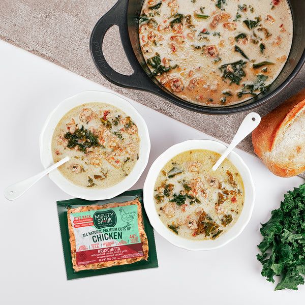 three bowls of soup and bread on a counter