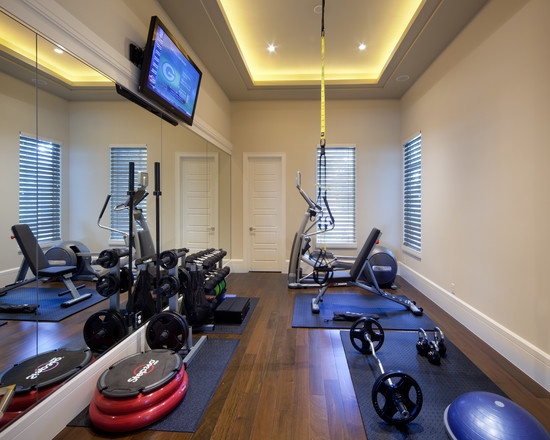 an exercise room with treadmills, machines and television on the wall that says back at it january mood